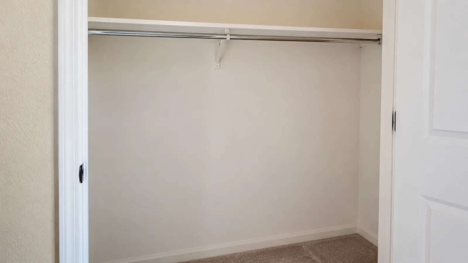A renter's closet with the hanging organizer removed, leaving no marks or holes on the closet rod or walls